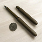 Earth brown Pokka Pocket Pen beside a quarter for size comparison