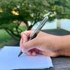 Onyx translucent black Pokka Pocket Pen being used to write outdoors